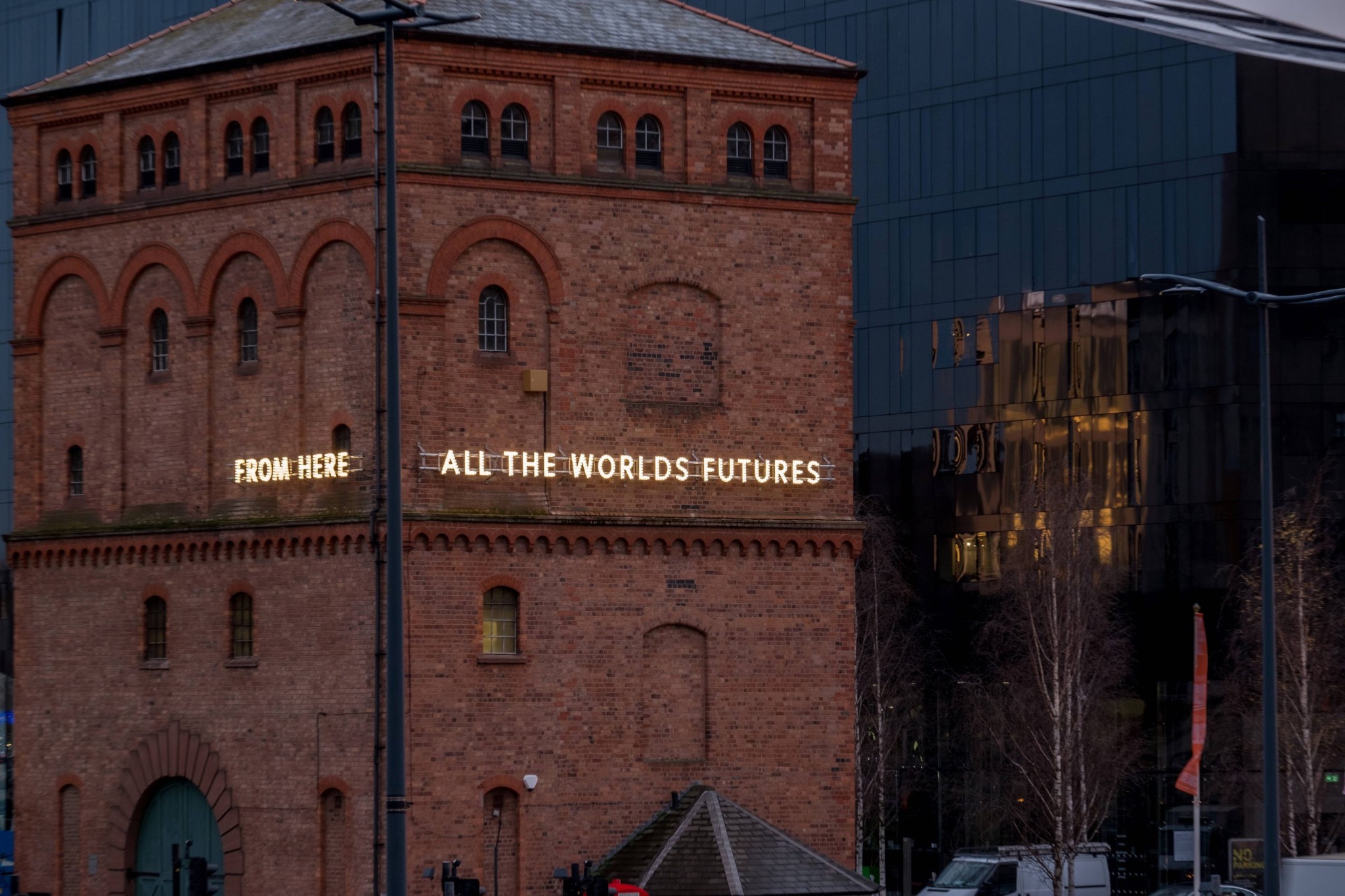 Liverpool dockfront architecture with illuminated words From Here All the World’s Futures